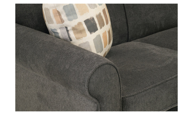 Gray sofa with a patterned pillow on a white background